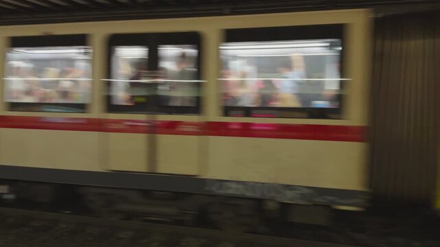 Subway Train Arriving at Urban Station Platform With Commuters Waiting and Graffiti Carriage in Rome, Italy