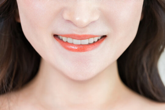 A woman's smile showing her white teeth; dental care, teeth whitening, orthodontics.