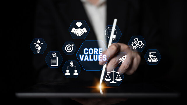 Hands Holding Stylus on Tablet with Icons Representing Core Values and Business Concepts in a Dark Background for Professional Use Fluxor.