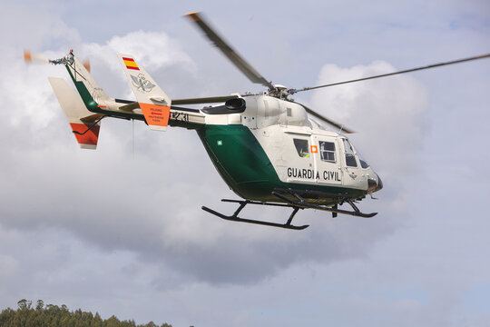 Guardia civil helicopter performing mountain rescue operation