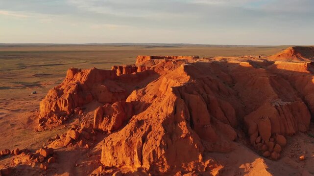 Aerial view of the red sandstone Flaming Cliffs at sunset in the Gobi Desert near Bulgan, Omnogovi, Mongolia.