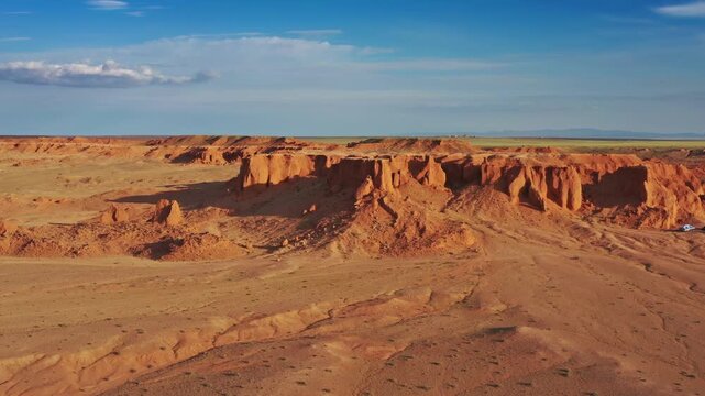 Aerial view of the Flaming Cliffs with red sandstone formations and vast desert landscape in Bulgan, Omnogovi, Mongolia.