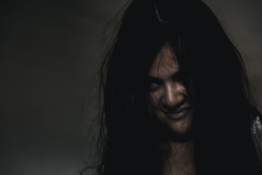 Portrait of Asian ghost or zombie horror creepy scary have hair covering the face