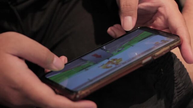 man playing games on a smartphone