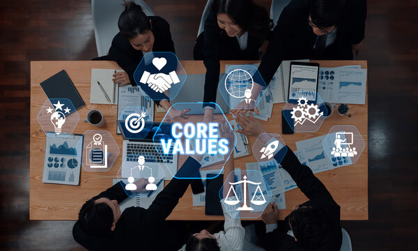 Diverse Business Team Collaborating on Core Values and Strategies in a Modern Office Setting with Digital Icons Representing Concepts of Success and Ethics Fluxor.