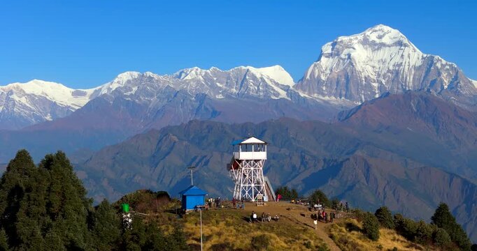 Poon Hill, Annapurna Circuit, Nepal, drone circling the tourists gathered at the summit view tower before the majestic Dhaulagiri mountain range