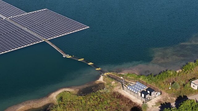 Floating solar panel farm on a lake generating clean, renewable energy with photovoltaic cells, an innovative and sustainable solution for electricity production connected to an onshore station