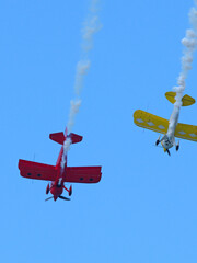 Red and Yellow Aerobatic Biplanes Performing Stunts at Pacific Airshow Gold Coast © blueringmedia