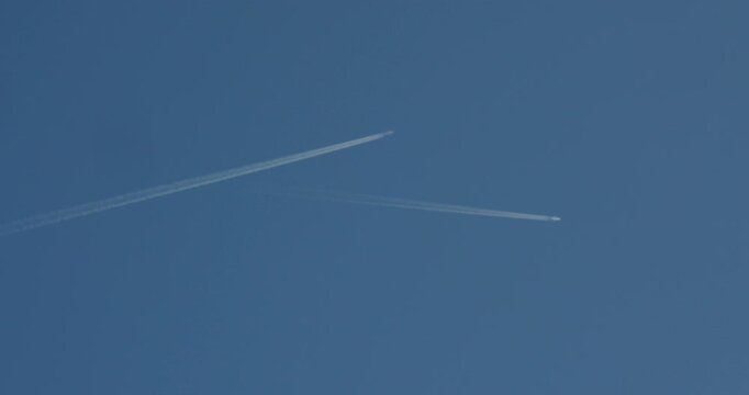 Extra wide shot looking up at two planes vapour trail contrail, at Basingwerk Abbey,