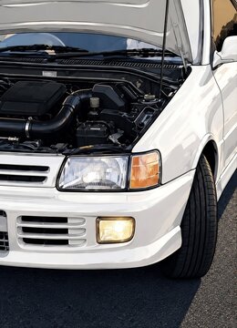White Performance Car with Open Hood and Detailed Engine Bay