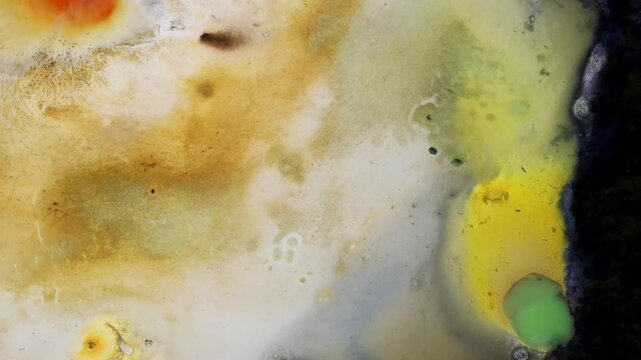 Rotorua geothermal surface in New Zealand, yellow, white and green mineral deposits, natural textures and thermal patterns for geology.