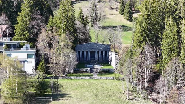 Paxmal monument surrounded by forest and grassy slopes in Walenstadt, Switzerland