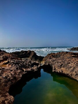 Rocky coastline with natural water pool and sea view
