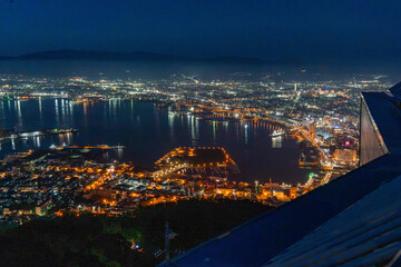 Fototapeta premium City Lights and Their Reflections on Hakodate Harbor at Dusk