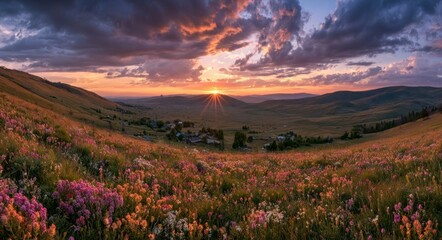 Fototapeta premium Mountain meadow at sunset with vibrant wildflowers and clouds