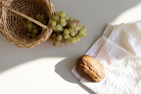 Minimal picnic flat lay with basket grapes and bread from above