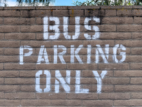 BUS PARKING ONLY sign on a wall