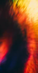 Defocused radiant film. Optical flash. Blur orange yellow color visual illuminated glimmer bright gleam foil on abstract dark black background. © golubovy