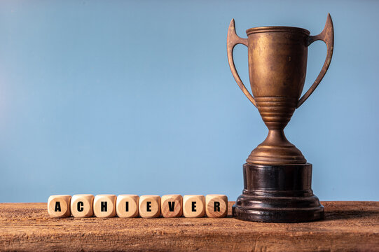 Gold Trophy Cup on Black and White Background Representing Award, Victory, Success, Achievement, Championship and First Place in Sports Competition
