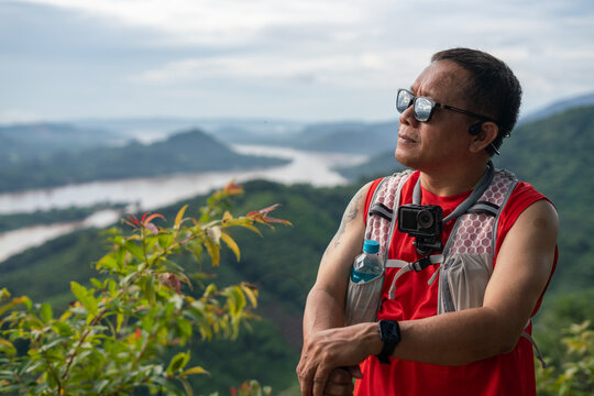 Outdoor Traveler Wearing Action Camera Enjoying Scenic Mountain and Lake View