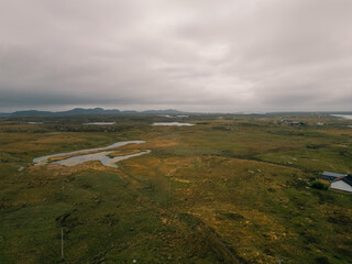 Aerial view of the coastal landscape of South Uist in the Outer Hebrides, with a road, scattered lochs and small rural settlements across the island terrain - South Uist, United Kingdom - 3 aug 2026 © IBRESTER
