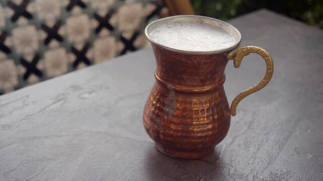 Exploring a turkish traditional drink ayran in a metal cup