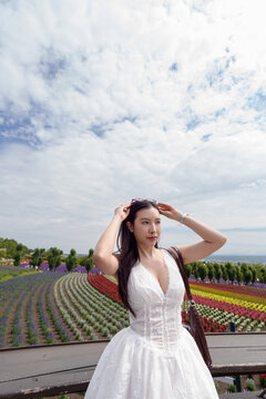 ​Woman with colorful flower fields background.