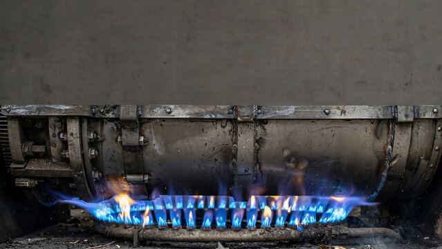 Industrial gas burner with blue flame in operation, highlighting the power and intensity of combustion.