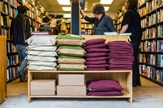 Independent Bookstore Interior with Stacks of Books and Merchandise
