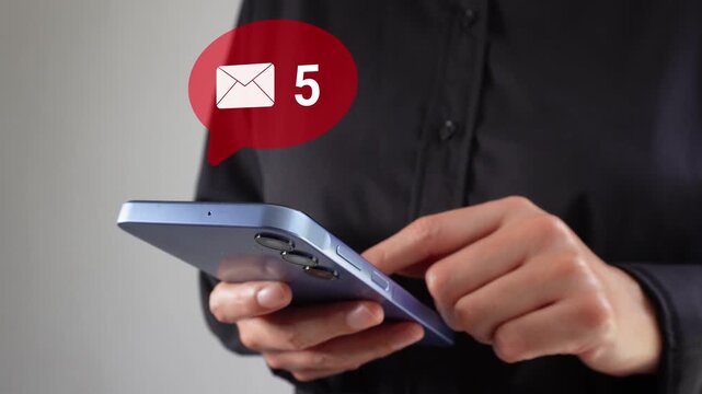 Close-up of hand using phone with email icon