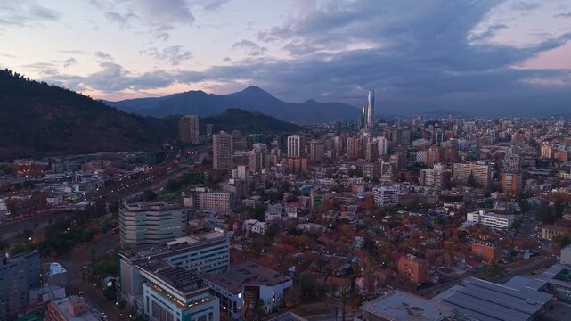 Aerial view of the Santiago city skyline featuring modern skyscrapers and urban architecture set against the backdrop of the Andes mountains in Santiago, Santiago Metropolitan, Chile.