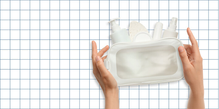 Cosmetics. Clear toilet bag is being held, showcasing various cosmetics and skincare essentials
