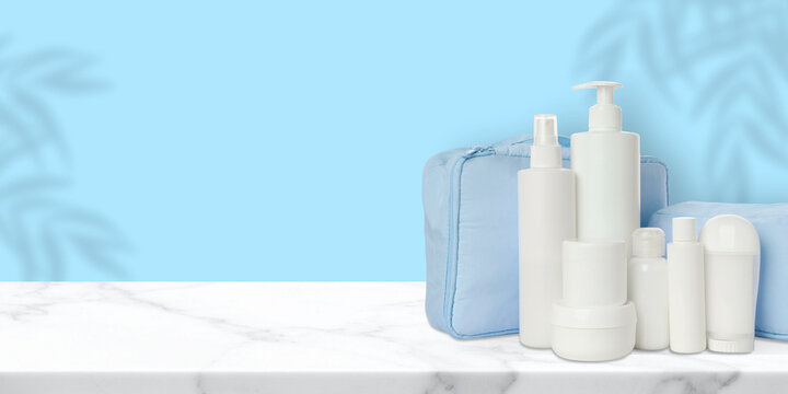 Toiletries. Cosmetics are neatly arranged alongside a toilet bag on marble surface