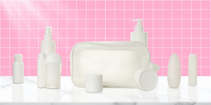 Cosmetics. Cosmetic products arranged alongside a stylish toilet bag on a marble surface