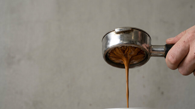 Fresh espresso pouring from a portafilter into a cup, capturing the rich aroma and intense flavor of a perfect coffee brew.