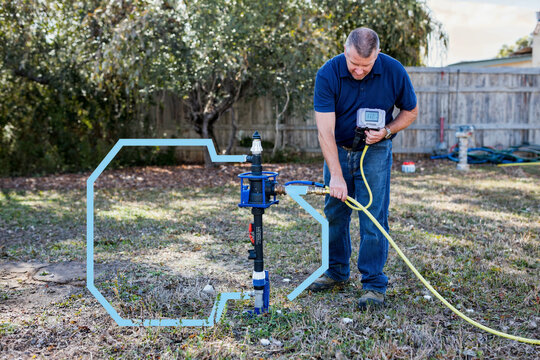 Professional Backflow Tester Inspecting Irrigation System