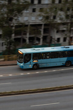 Blue Caio Apache Transit Bus Driving on Urban Highway, High Angle Panning Shot