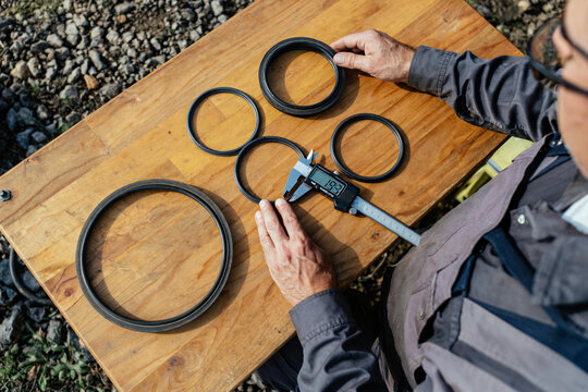Technician Measuring Industrial Pump Seals with Digital Calipers