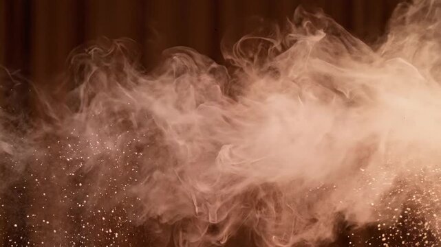 Pink powder burst explosion on dark background with lingering dust cloud