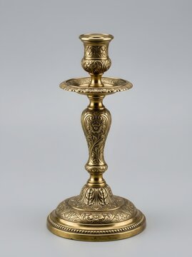 A vintage ornate brass candlestick holder crafted with intricate floral patterns for dining room table decor and interior styling displays which enhances the warmth of any traditional
