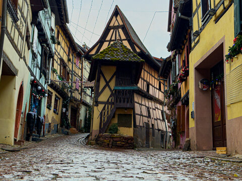 Eguisheim village street with traditional half timbered houses
