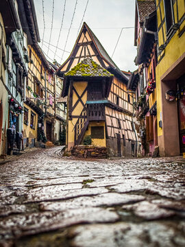 Eguisheim village street with traditional half timbered house