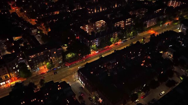 Aerial drone footage of the residential area surrounding Arsenal FC's Emirates Stadium in North London, England, captured at night. The footage showcases illuminated streets, and night life.