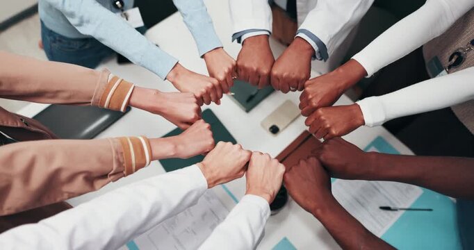 Medical, circle and people in clinic with fist bump, achievement and motivation in hospital teamwork. Above, diversity and doctor with support gesture, success and encouragement in healthcare synergy