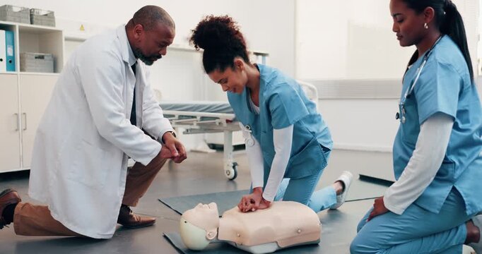 Medical, team or dummy in clinic for cpr training, compression fraction or cardiac arrest technique. People, physician and nurses with mannequin for life saving procedure, practical or certification