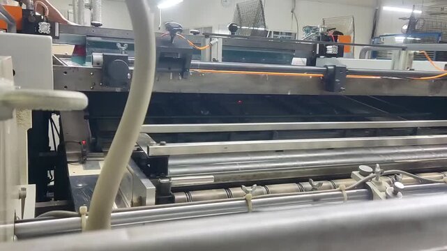 Industrial automatic screen printing machine in operation