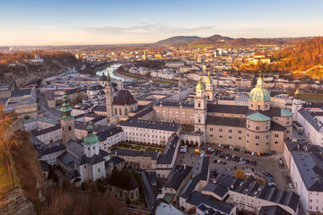 Fototapeta premium Elevated view of Salzburg historic center with Salzburg Cathedral, church towers and the Salzach River in Austria.