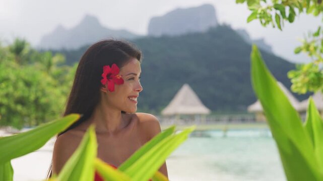 French Polynesia Vacation Travel woman walking on paradise motu beach on holidays on Bora Bora with Mount Otemanu. Girl in pareo in Tahiti, French Polynesia. Raw video of real woman without makeup