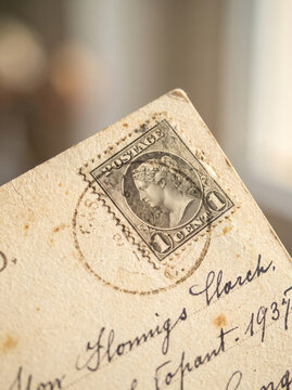 Antique handwritten postcard with green postal stamp and elegant vintage handwriting