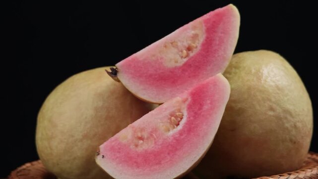 Fresh pink guava fruit with whole and half slice